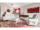 Comfortable living room featuring a modern white sofa, accent chair, hardwood floors, and stylish decor at 17132 E Hillcrest Dr, Fountain Hills, AZ 85268
