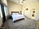 Spacious main bedroom boasts neutral tones, ceiling fan, ensuite access, and plush carpeting for a serene retreat at 17132 E Hillcrest Dr, Fountain Hills, AZ 85268
