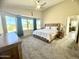 Bright main bedroom features large windows offering neighborhood views and a ceiling fan for added comfort at 17132 E Hillcrest Dr, Fountain Hills, AZ 85268
