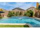 Beautiful backyard featuring swimming pool with safety net and mature tropical landscaping at 18422 W Clinton St, Surprise, AZ 85388