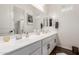 Bright bathroom with double vanity, framed mirrors, and ample counter space, offering a modern and functional design at 18422 W Clinton St, Surprise, AZ 85388