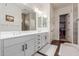 Bright bathroom features double sinks, modern fixtures, wood-like tile floors, and a walk-in closet at 18422 W Clinton St, Surprise, AZ 85388