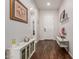 Bright foyer with wood floors, a white front door, decorative furniture, and complementary wall decor at 18422 W Clinton St, Surprise, AZ 85388