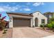 Charming single-story home featuring a two-car garage and a well-maintained, drought-resistant landscaped front yard at 18422 W Clinton St, Surprise, AZ 85388