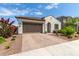 Charming single-story home featuring a two-car garage and a well-maintained, drought-resistant landscaped front yard at 18422 W Clinton St, Surprise, AZ 85388