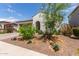 Charming single-story home featuring a two-car garage and a well-maintained, drought-resistant landscaped front yard at 18422 W Clinton St, Surprise, AZ 85388