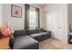 Comfortable living room with a gray sectional sofa, soft carpet, and natural light at 18422 W Clinton St, Surprise, AZ 85388