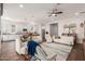 Open-concept living room with modern furnishings, a large kitchen island and a full kitchen in the background at 18422 W Clinton St, Surprise, AZ 85388