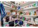 Organized pantry featuring ample shelving filled with food items and small appliances for convenient storage at 18422 W Clinton St, Surprise, AZ 85388