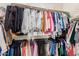 Organized walk-in closet with double rods and shelves for optimal storage and organization at 18422 W Clinton St, Surprise, AZ 85388