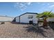 Backyard with rock landscaping, palm tree, and small patio at 205 S Higley Rd # 286, Mesa, AZ 85206