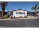 Charming single-story home featuring a covered carport and well-maintained desert landscaping at 205 S Higley Rd # 286, Mesa, AZ 85206