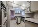 Well-lit kitchen features white appliances, white cabinets, black counters, and breakfast bar at 205 S Higley Rd # 286, Mesa, AZ 85206