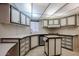 Well-lit kitchen features white cabinets with black trim, curved counters and a breakfast bar at 205 S Higley Rd # 286, Mesa, AZ 85206