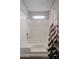 Shower-tub combo with white surround, a shower head, and a patterned shower curtain at 205 S Higley Rd # 286, Mesa, AZ 85206