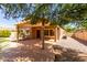 Covered patio with fan and outdoor seating overlooks the backyard at 2140 S Benton Cir, Mesa, AZ 85209