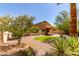 Backyard with desert landscaping, extended patio, and synthetic grass at 2140 S Benton Cir, Mesa, AZ 85209
