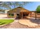 Backyard with desert landscaping, extended patio, and synthetic grass at 2140 S Benton Cir, Mesa, AZ 85209