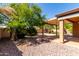 Backyard with an extended covered patio and desert landscaping at 2140 S Benton Cir, Mesa, AZ 85209
