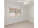Sunlit bedroom features a window with blinds and neutral carpeting at 2140 S Benton Cir, Mesa, AZ 85209