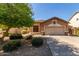 Charming home featuring a manicured lawn, desert landscaping, and a two-car garage at 2140 S Benton Cir, Mesa, AZ 85209