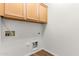 Bright laundry area features wood style flooring and storage cabinets at 2140 S Benton Cir, Mesa, AZ 85209
