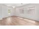 Bright living room featuring hardwood floors, and abundant natural light from multiple windows at 2140 S Benton Cir, Mesa, AZ 85209