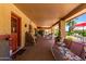 Spacious covered back patio with furniture, providing a relaxing outdoor living space with a pool view at 2232 E Inglewood St, Mesa, AZ 85213