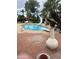 Backyard pool surrounded by brick patio, lush greenery, a diving board, and a water slide at 2232 E Inglewood St, Mesa, AZ 85213