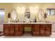 Bathroom with double sinks, wooden vanity, and ample counter space at 2232 E Inglewood St, Mesa, AZ 85213