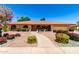 Charming single-story home featuring a red tile roof, arched windows, desert landscaping, and a concrete walkway under a blue sky at 2232 E Inglewood St, Mesa, AZ 85213