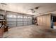 Spacious garage featuring a paneled garage door and built-in storage cabinets along the back wall at 2232 E Inglewood St, Mesa, AZ 85213
