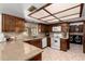 Kitchen with granite counters, wood cabinets, white appliances and breakfast nook to an adjacent laundry room at 2232 E Inglewood St, Mesa, AZ 85213