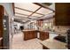 Modern kitchen with stainless steel appliances, granite countertops, and an open floorplan view into the living room at 2232 E Inglewood St, Mesa, AZ 85213