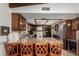 Spacious kitchen featuring granite countertops, wooden cabinets, stainless steel appliances, and seating at the island at 2232 E Inglewood St, Mesa, AZ 85213