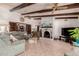 Cozy living room with beamed ceilings, a fireplace, and an entertainment center at 2232 E Inglewood St, Mesa, AZ 85213
