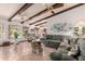 Open living room with beamed ceilings, ceiling fans, and large windows offering abundant natural light at 2232 E Inglewood St, Mesa, AZ 85213