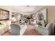 Bright living room features a large window, mirrored wall, neutral color scheme, and comfortable seating arrangement at 2232 E Inglewood St, Mesa, AZ 85213