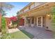 The backyard features a covered patio with a chiminea, artificial turf, and flowering shrubs at 2455 E Broadway Rd # 68, Mesa, AZ 85204