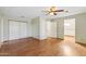 Bedroom features a ceiling fan, closet, and wood laminate flooring at 2455 E Broadway Rd # 68, Mesa, AZ 85204