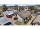 Aerial view of a light colored two-story home with a brown roof, landscaping, and carport at 2455 E Broadway Rd # 68, Mesa, AZ 85204