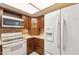 A well-lit kitchen featuring wooden cabinets, modern appliances, and tile backsplash at 2455 E Broadway Rd # 68, Mesa, AZ 85204