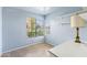 A light blue room with a large window, shelves, and a lamp at 2455 E Broadway Rd # 68, Mesa, AZ 85204