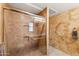 Bathroom with tiled shower and textured walls at 2455 E Broadway Rd # 68, Mesa, AZ 85204