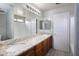 Bathroom with a granite vanity top, large mirror, and bathtub at 24709 N 75Th Way, Scottsdale, AZ 85255