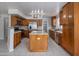 Spacious kitchen featuring granite counters, an island, stainless steel appliances and wood cabinetry at 24709 N 75Th Way, Scottsdale, AZ 85255