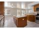 Gourmet kitchen with granite countertops, stainless appliances, an island, and an adjacent living space at 24709 N 75Th Way, Scottsdale, AZ 85255