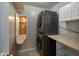 A practical laundry room featuring a stacked washer/dryer and convenient built-in ironing board at 24709 N 75Th Way, Scottsdale, AZ 85255