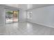 Bright, open living room with tiled floors, large windows, and a sliding glass door leading to the backyard at 24709 N 75Th Way, Scottsdale, AZ 85255
