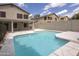 A backyard pool is surrounded by light stone tile and a covered patio attached to the home at 24709 N 75Th Way, Scottsdale, AZ 85255